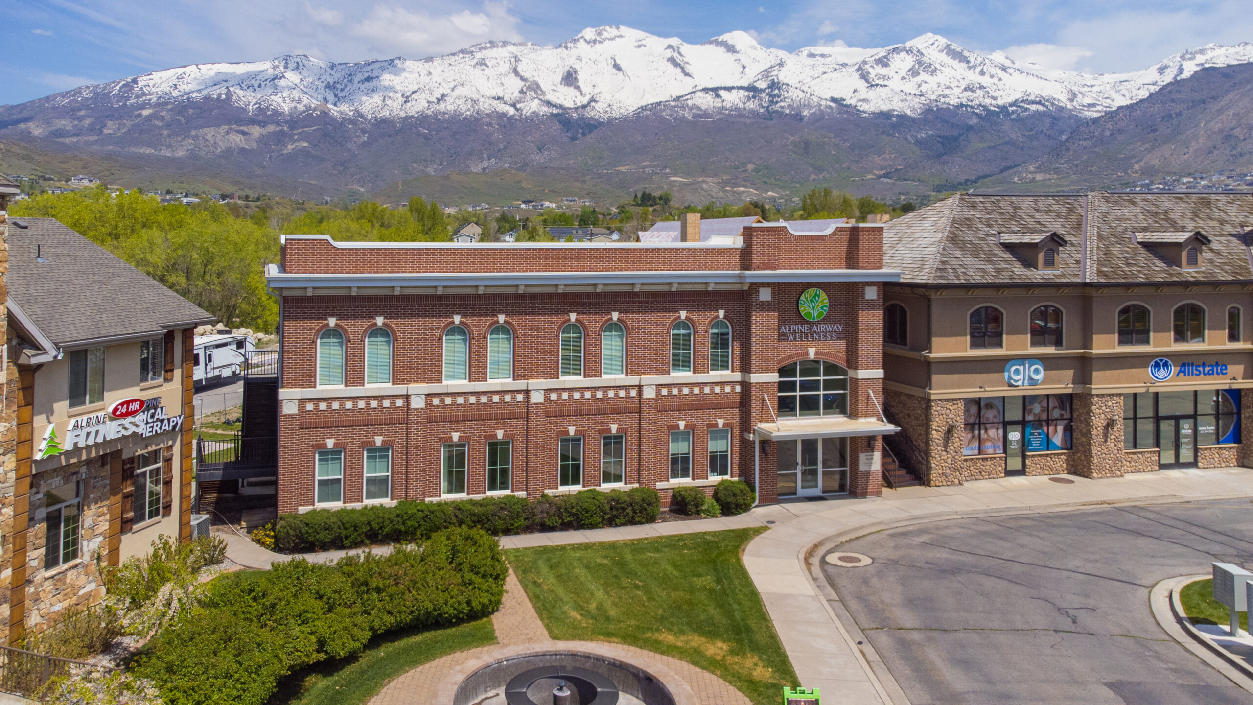 The Alpine Airway Wellness office building in Alpine, Utah, with snow-capped mountains behind it